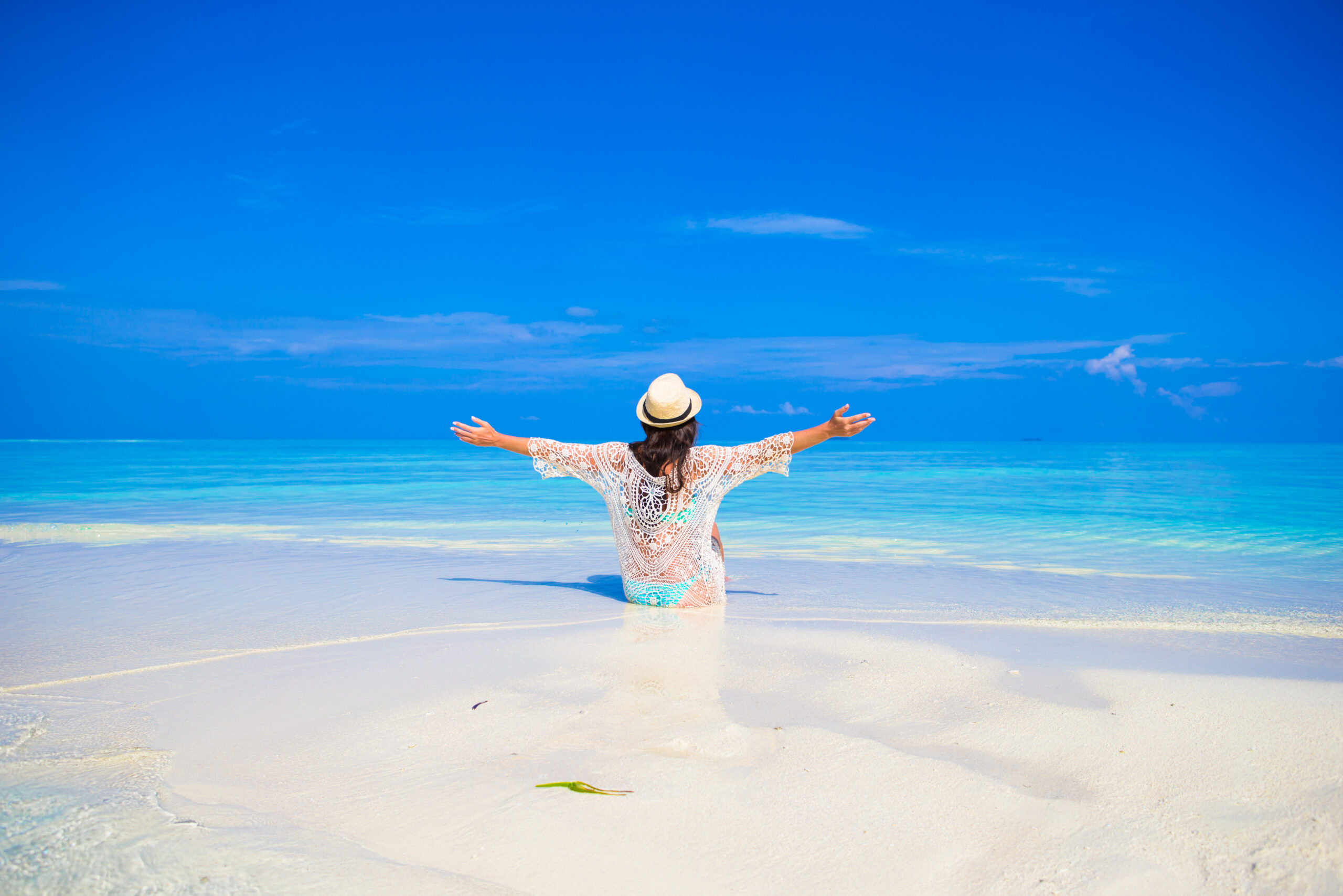 Young woman, relaxed and happy and enjoying herself on the beach
